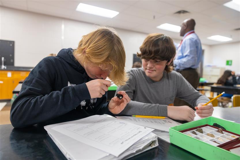 Students study rocks in a science lab